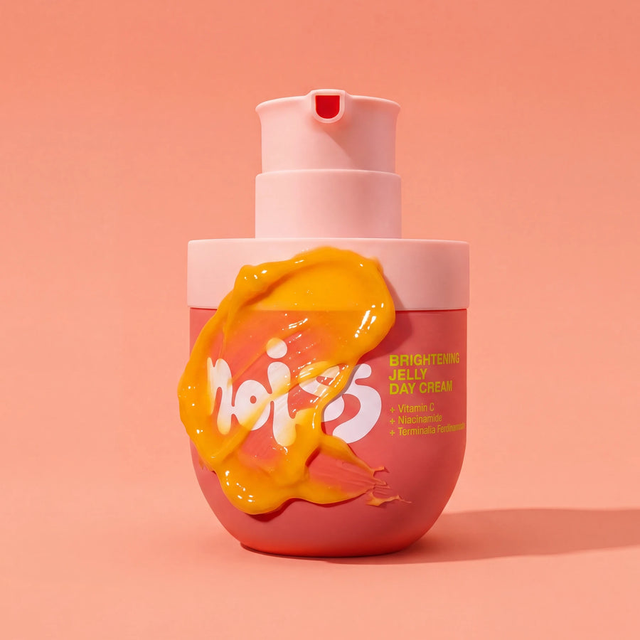 NOISS Brightening Jelly Day Cream pump bottle with golden jelly texture smeared on front