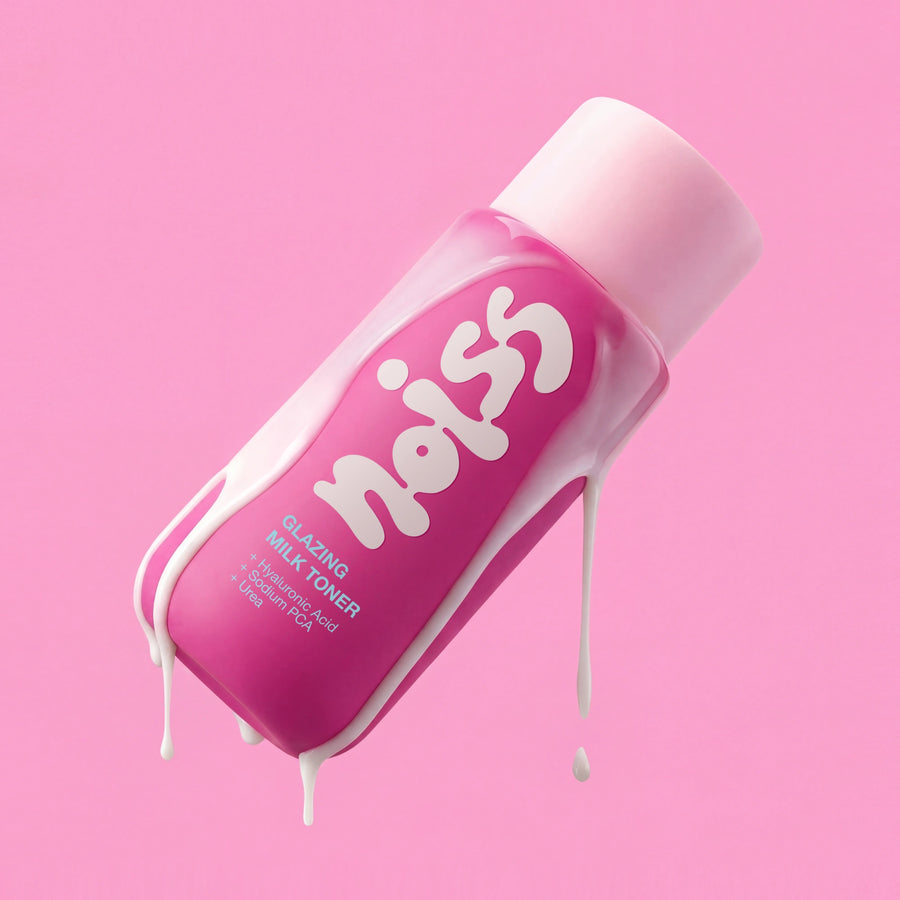 NOISS Glazing Milk Toner bottle tilted with milky texture dripping