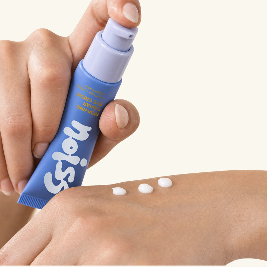 NOISS Reviving Caviar Eye Cream dispensed on hand